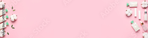 Cosmetic products and cotton flowers on pink background, flat lay. Banner design with space for text