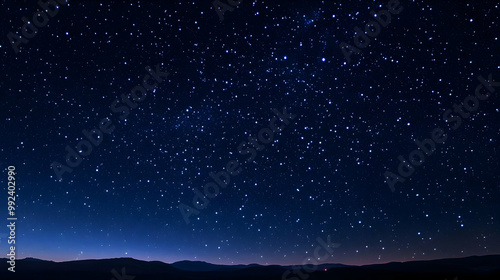 A Night Sky Filled with Countless Stars Above a Dark Mountain Range, a Stunning Display of Celestial Beauty.