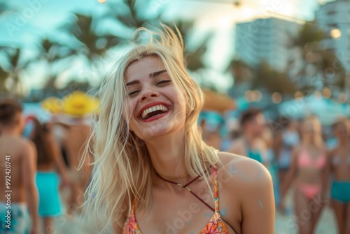 young woman with golden blonde hair smiles joyfully under the sunlight at an outdoor festival, surrounded by blurred lights and people in the background.