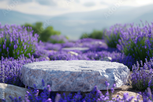 Closeup shot of a marble stone podium on the ground, surrounded by lavender flowers in an outdoor refreshing scene.