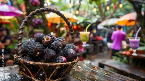 Basket of jabuticaba fruits placed wooden table tropical beachside caf brightcolored drinks umbrellas blurred in the background emphasizing the fruits exotic appeal Scientific name Plinia cauliflora photo