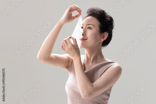 Beautiful Woman Using Face Mask photo