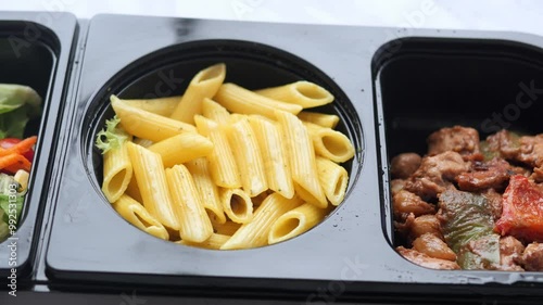 A HeatandEat Meal featuring Pasta along with a delicious and Savory Chicken Dish photo