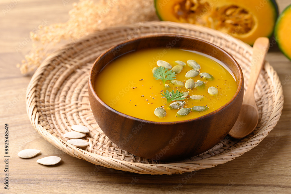 Pumpkin soup in wooden bowl, Homemade food in autumn season Pumpkin soup in wooden bowl, Homemade food in autumn season