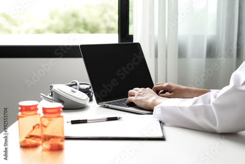 Female doctor holding a medicine bottle is checking the quality of medicine for any side effects the patient or not and recording patient information at the hospital. medical and health care concept