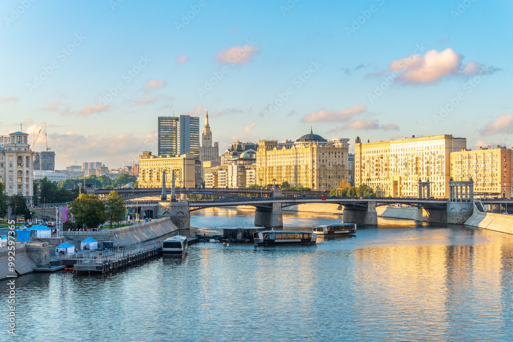 Naklejka premium Panoramic view Borodinsky bridge, river Moscow, old buildings and high towers. View of the Borodinsky Bridge and the embankment in Moscow
