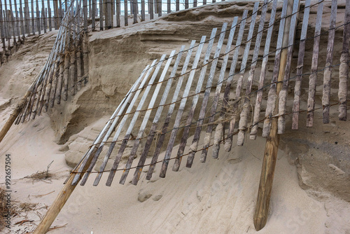 BEACH EROSION WITH BROKEN FENCE