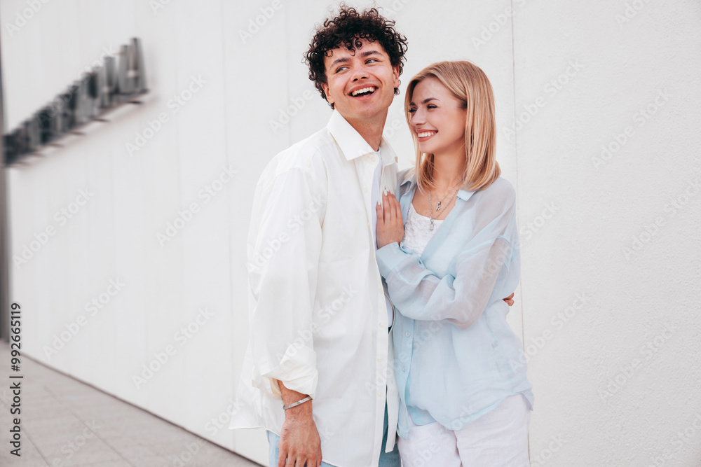 Smiling beautiful woman and her handsome boyfriend. Couple in casual summer clothes. Happy cheerful family. Female and man having fun. They posing in the street in sunny day. Having tender moments Smiling beautiful woman and her handsome boyfriend. Couple in casual summer clothes. Happy cheerful family. Female and man having fun. They posing in the street in sunny day. Having tender moments