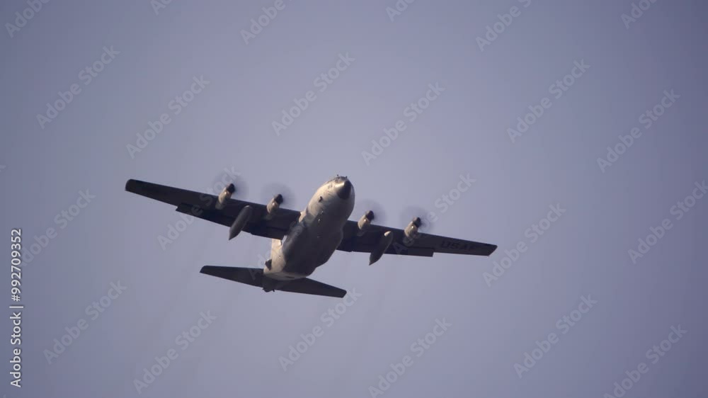 Lockheed C-130 Hercules military transport aircraft flying overhead ...