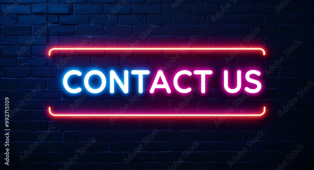 Obraz premium contact us word lettering glowing with neon light on dark brick wall background