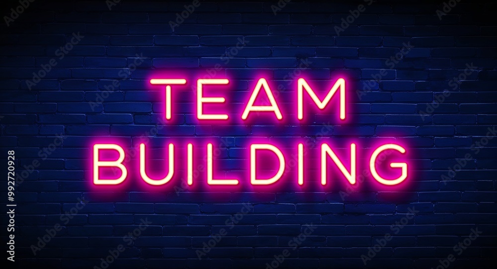 team building word lettering glowing with neon light on dark brick wall background team building word lettering glowing with neon light on dark brick wall background