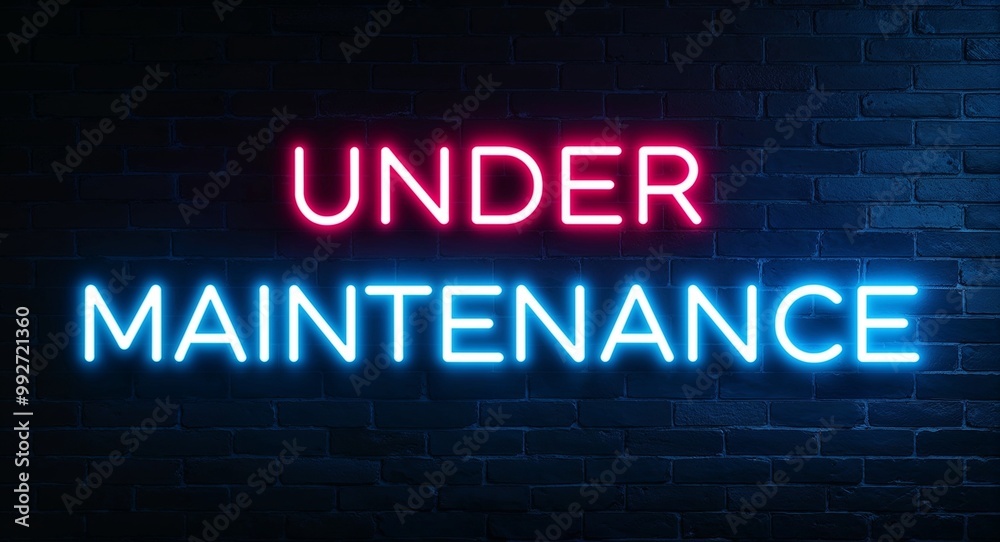 under maintenance word lettering glowing with neon light on dark brick wall background