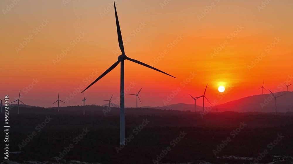 Wind turbines at sunset,Offshore wind power generation, windmill wind power Wind turbines at sunset,Offshore wind power generation, windmill wind power