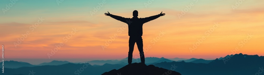 A person stands triumphantly on a mountain peak, arms raised in celebration against a colorful sunset sky. A person stands triumphantly on a mountain peak, arms raised in celebration against a colorful sunset sky.