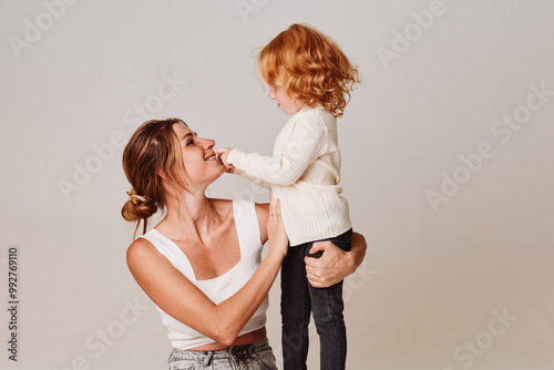 Mother and daughter bonding moment affectionate kiss in the air showing love and care