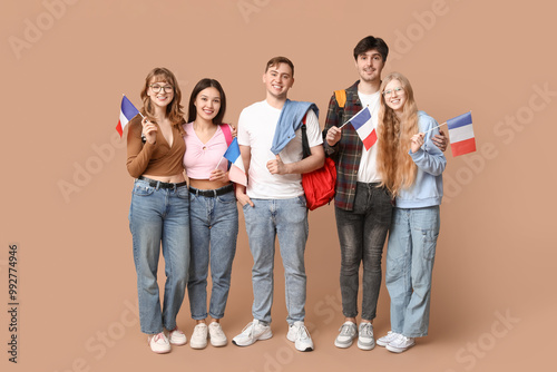 Group of students with French flags on beige background