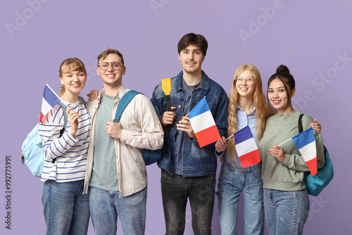Group of students with French flags on lilac background