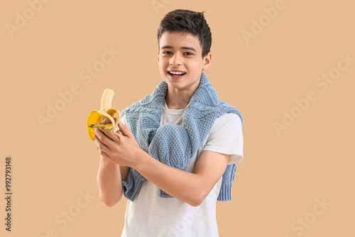 Teenage boy with banana on ...