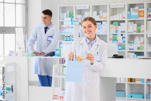 Female pharmacist packing order at pharmacy