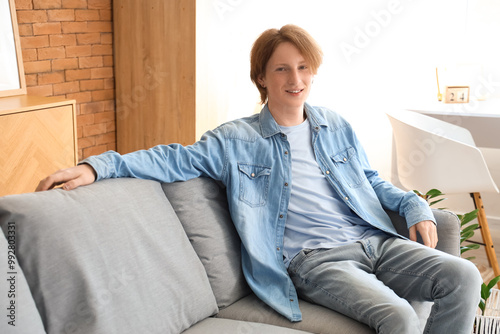 Redhead teenage boy sitting...