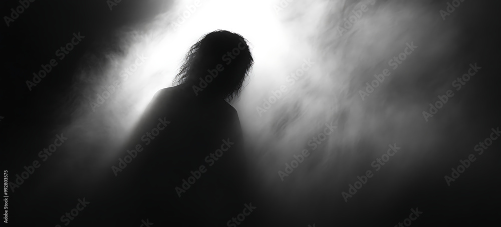 A dark, blurry photograph of an object with light shining on it A dark, blurry photograph of an object with light shining on it