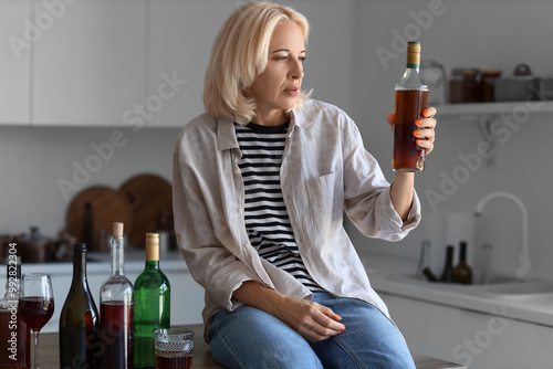 Mature woman with drinks at...