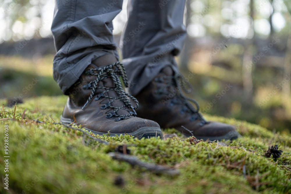 Close-up of hiking boots standing on green moss in a forest Close-up of hiking boots standing on green moss in a forest