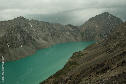 View of karakul lake surrounded by mountains in kyrgyzstan photo