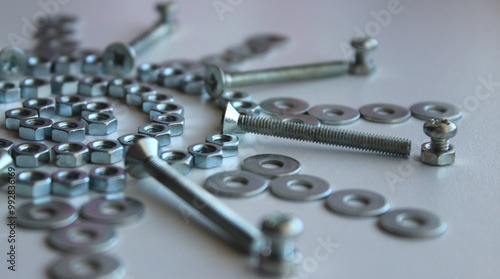 Shiny Metalware Items Laid Out In Decorative Pattern On White Table Macro Shot Stock Photo
 photo