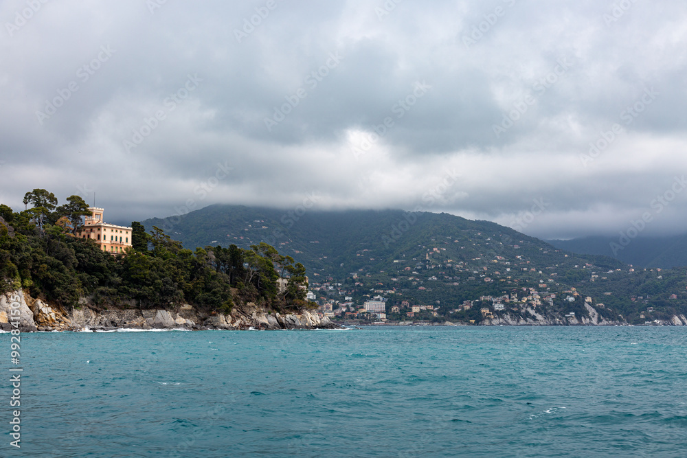 Small city near Portofino from the sea with dramatic sky Small city near Portofino from the sea with dramatic sky