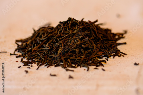 A handful of black tea lies on the table