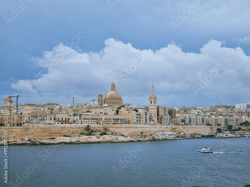 Panoramic view to Valetta and the dome of Basilica of Our Lady of Mount Carmel in cloudy weather taken from Sliema, Malta photo