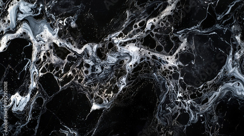 A foamy oily pattern. A black and white abstract painting with white swirls and dots. Space backdrop. A futuristic surface. There is movement and energy in the painting