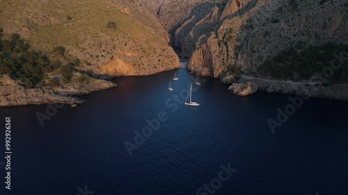 Aerial Reveal of Boats in Touristic Bay on Mallorca Rocky Coastline at Sunset