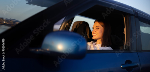 positive woman driver driving a car photo