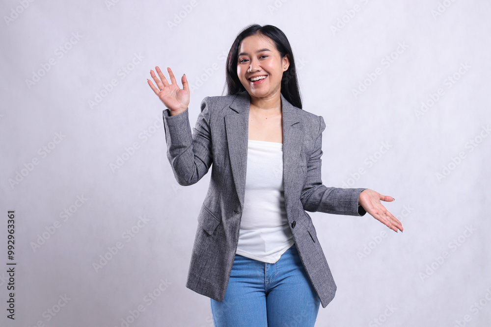 expression of cheerful beautiful young woman asia raising both palms up and down wearing grey suit and jeans standing isolated on white background. for advertising content, fashion, banner, magazine expression of cheerful beautiful young woman asia raising both palms up and down wearing grey suit and jeans standing isolated on white background. for advertising content, fashion, banner, magazine