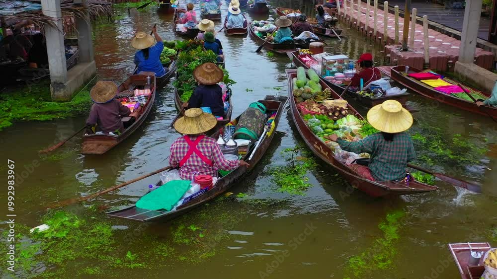 Aerial view Damnoen Saduak floating market, Farmer go to sell organic product, fruit, vegetable and Thai cuisine, Tourist visiting by boat, Ratchaburi, Thailand, Famous floating market in Thailand.