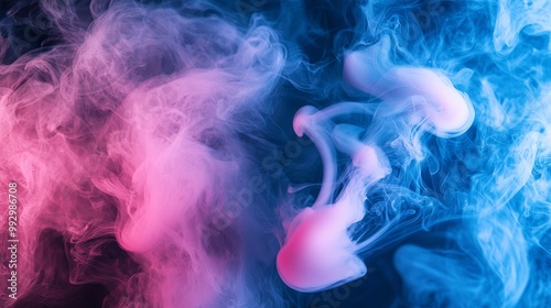 A captivating blend of pink and blue smoke, creating an abstract and ethereal atmosphere with swirling patterns.