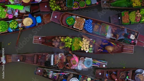 Aerial view Damnoen Saduak floating market, Farmer go to sell organic product, fruit, vegetable and Thai cuisine, Tourist visiting by boat, Ratchaburi, Thailand, Famous floating market in Thailand.