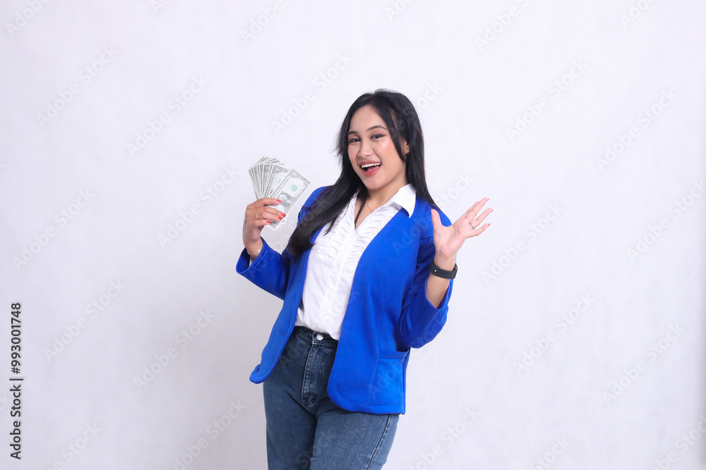 beautiful mature office woman wearing blue formal suit standing happily to camera holding dollar bills to right and side isolated white background. for transaction, finance, business content beautiful mature office woman wearing blue formal suit standing happily to camera holding dollar bills to right and side isolated white background. for transaction, finance, business content