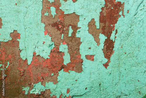 Grunge wall texture background. Paint cracking off dark wall with rust underneath