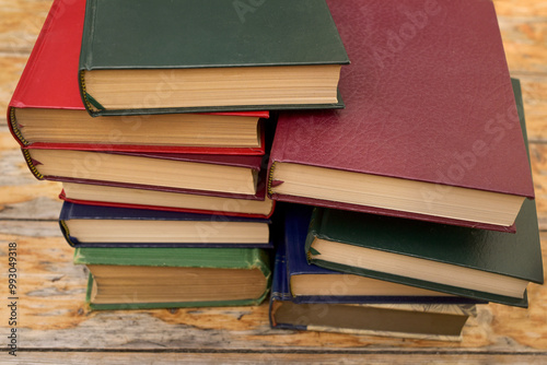 Cuadro en lienzo Pile of old hardcover books on wooden rustic background