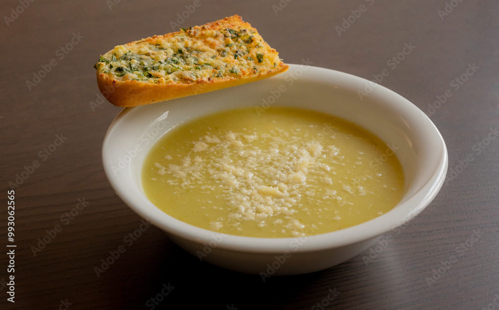 Zucchini Cream Soup with Parmesan and Garlic Bread Close-Up on Dark Background