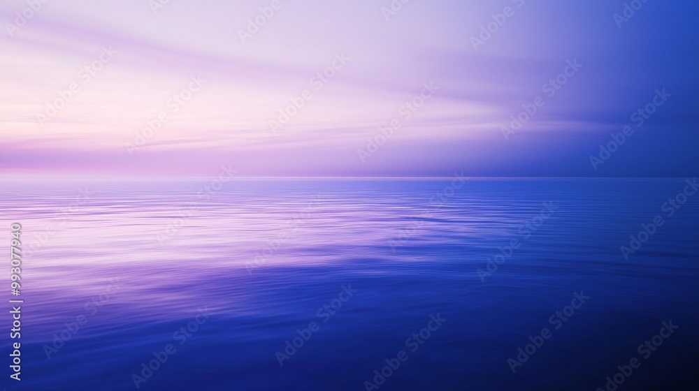 Fototapeta premium The calm ocean reflects the setting sun, creating a peaceful atmosphere with vibrant colors perfect for relaxation and meditation