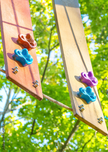 Game element of a work out playground with climbing elements in an adventure park. Rope park at a high altitude in the forest. photo