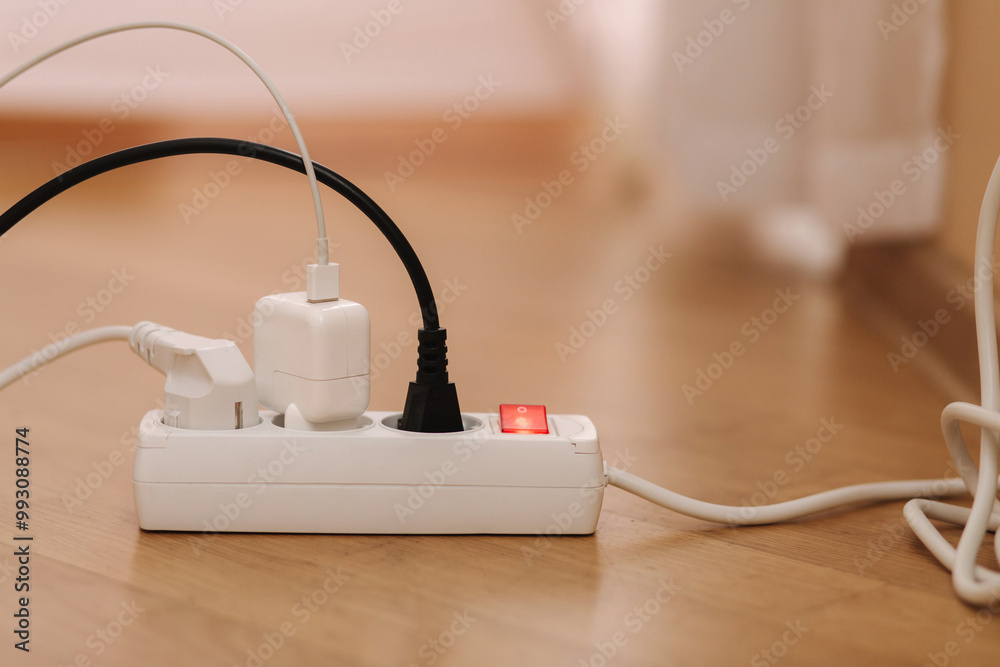 White cable connector for overloaded power boards at home. Close up focus at a plug foreground. White cable connector for overloaded power boards at home. Close up focus at a plug foreground.