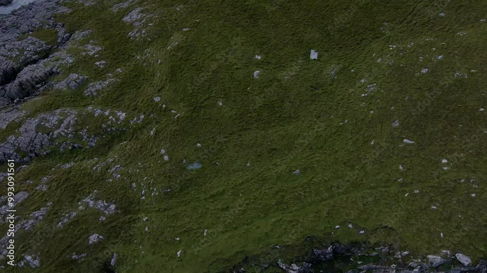 Drone shot panning up flying towards the Neist Point lighthouse in the Scottish highlands. Drone shot panning up flying towards the Neist Point lighthouse in the Scottish highlands.