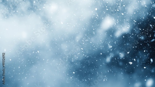 Abstract Winter Snowfall Background with Blurred Snowflakes and Cold Blue Tones
