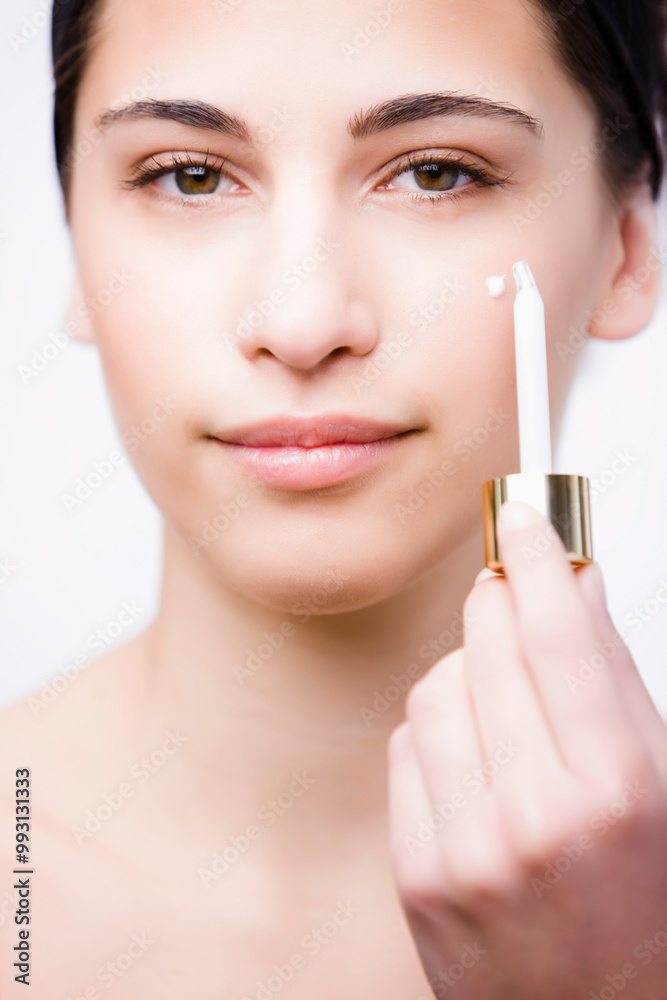 Close up of a young woman applying an anti-aging serum on her face with a dropper
Close up of a young woman applying an anti-aging serum on her face with a dropper