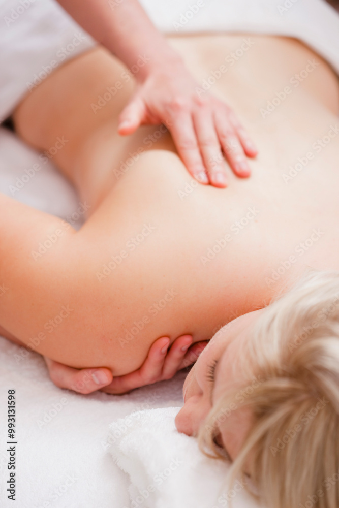 Masseur hands giving a woman a shoulder massage
Masseur hands giving a woman a shoulder massage